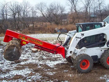 A construction worker using a Pro Series Wood Splitter attachment to move logs.